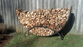 Firewood stacked in half round carrier.