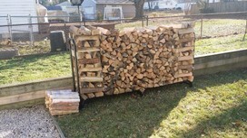 Delivered firewood stacked correctly with kindling at side.
